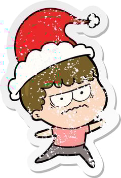 distressed sticker cartoon of a annoyed man wearing santa hat vector