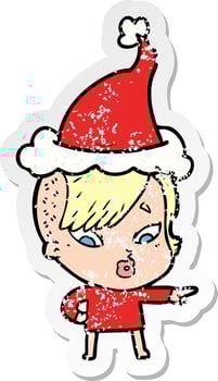 distressed sticker cartoon of a surprised girl pointing wearing santa hat vector