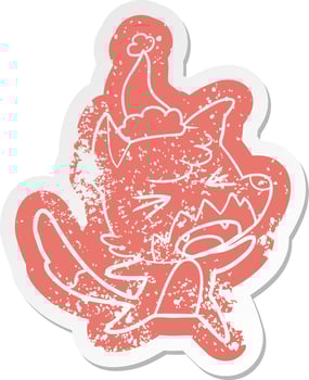 angry cartoon distressed sticker of a fox wearing santa hat vector