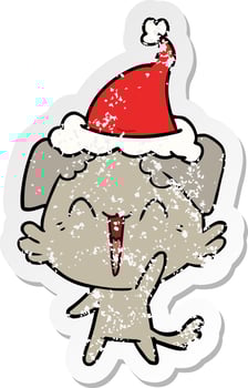 happy little dog distressed sticker cartoon of a wearing santa hat vector