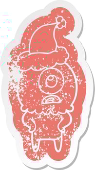 cartoon distressed sticker of a cyclops alien spaceman wearing santa hat vector