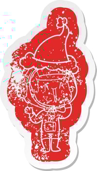 laughing cartoon distressed sticker of a astronaut wearing santa hat vector