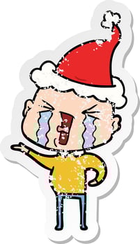 distressed sticker cartoon of a crying bald man wearing santa hat vector