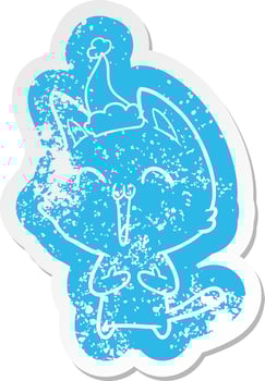 happy cartoon distressed sticker of a cat wearing santa hat vector