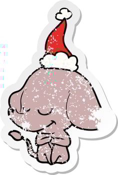 distressed sticker cartoon of a smiling elephant wearing santa hat vector