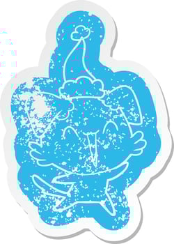 happy little dog cartoon distressed sticker of a wearing santa hat vector