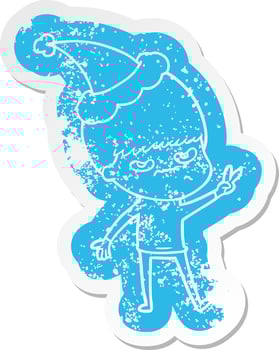 annoyed cartoon distressed sticker of a boy wearing santa hat vector