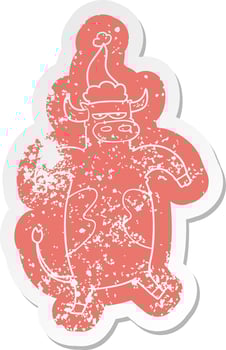 cartoon distressed sticker of a bull wearing santa hat vector