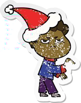 distressed sticker cartoon of a angry man wearing santa hat vector