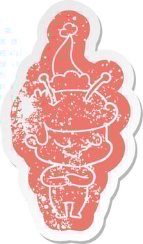friendly cartoon distressed sticker of a spaceman wearing santa hat vector