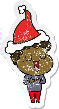 laughing distressed sticker cartoon of a man wearing santa hat vector