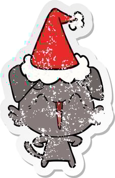 happy little dog distressed sticker cartoon of a wearing santa hat vector