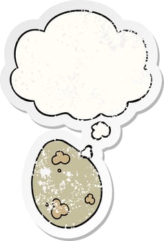 cartoon egg and thought bubble as a distressed worn sticker vector