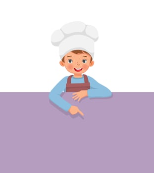 cute little boy in chef hat and apron standing behind empty board pointing finger to blank banner for copy space vector
