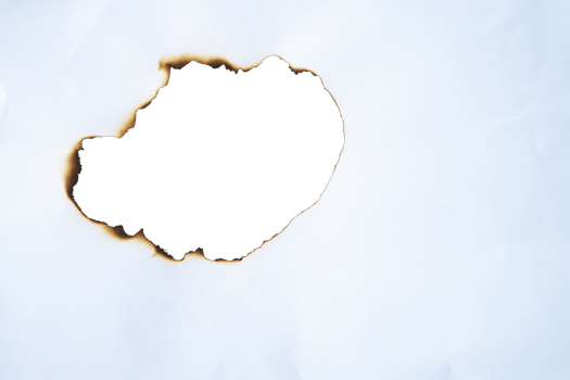 burnt paper frame for texture overlay. damaged white paper with burnt stain in transparent background. blank ripped paper edge for a design element. png