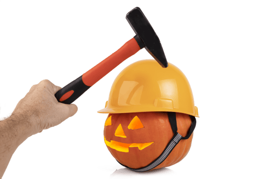 Orange festive pumpkin with glowing eyes in the form of a lantern, halloween, in a yellow construction helmet and a male hand with a hammer. Holiday security concept. Transparent background. PNG