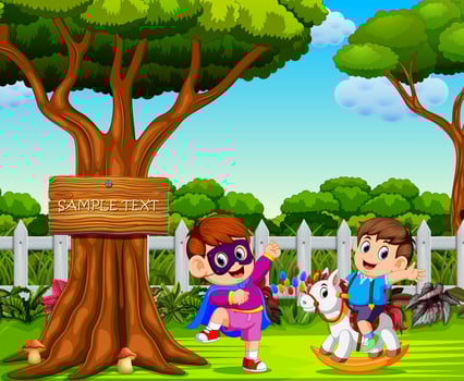 the boy uses the superhero costume and play with his friend near the big tree vector