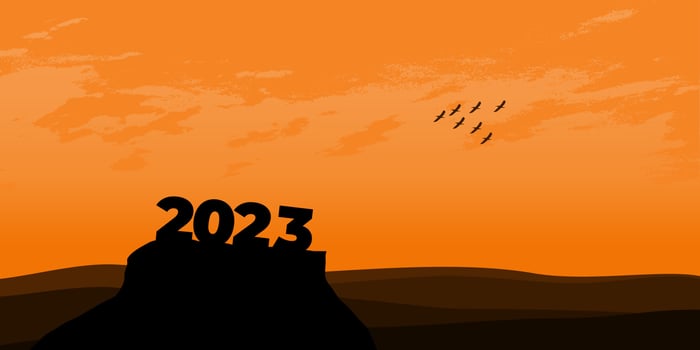 Happy New year 2023 with large silhouette letters on the mountain with a beautiful sunset for success concept. new year concept vector