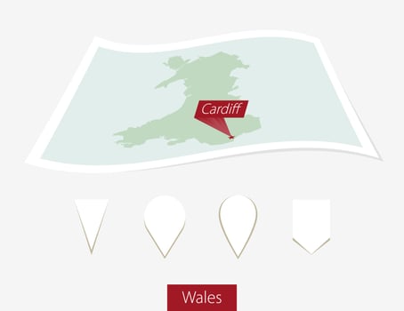 Curved paper map of Wales with capital Cardiff on Gray Background. Four different Map pin set. vector