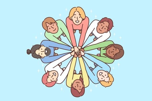 Multiracial people stand in circle with hands outstretched to demonstrate friendship. Men and women look up demonstrating multiracial diversity and national tolerance vector