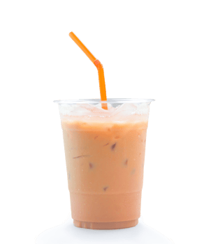 Orange Thai iced condensed milk tea in transparent plastic glass with straw is isolated with clipping path and shadow in png file format