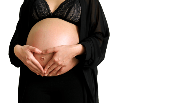 Pregnant woman in black dress forming heart-shape with her hands over her stomach isolated on transparent background. Pregnancy 7-9 months, symbol, love, new life, care baby. png transparency