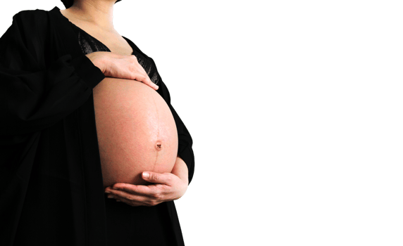 Pregnant woman wearing black dress and holds hands on swollen belly isolated on transparent background and copy space with clipping path. Pregnancy 7-9 months, motherhood, love, expect, care baby. png