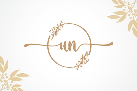luxury gold signature initial un logo design isolated leaf and flower vector