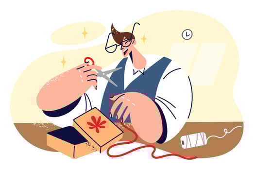 Man makes giftbox sitting at table and cutting piece of red ribbon to create beautiful gift box. Happy guy prepares giftbox for girlfriend in honor of birthday or christmas celebration vector