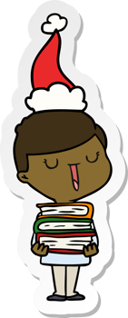 hand drawn sticker cartoon of a happy boy with stack of books wearing santa hat png