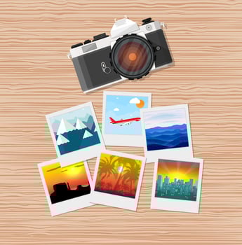 Wooden travellers desk with photos and camera. travel and vacation concept. vector illustration in flat design