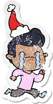 hand drawn distressed sticker cartoon of a man crying wearing santa hat png