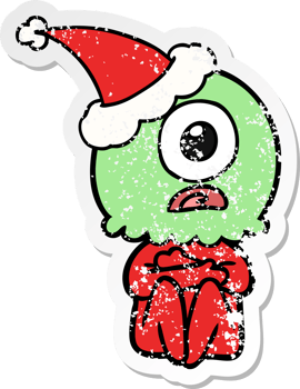 hand drawn distressed sticker cartoon of a cyclops alien spaceman wearing santa hat png
