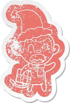 shouting quirky cartoon distressed sticker of a monkey carrying christmas gift wearing santa hat png