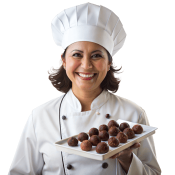Smiling female chef presenting a plate of delicious desserts png
