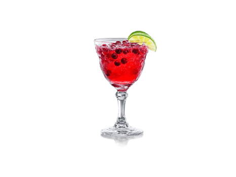 Cranberry soda in a crystal goblet cranberries and lime wedges vibrant red splash in png