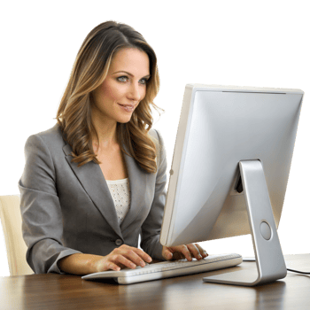A professional woman in a grey blazer focuses on her work while using a desktop computer at her office desk png
