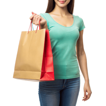 A woman in a green top and jeans holding shopping bags, smiling png
