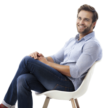 Man with a striped shirt and jeans sitting on a modern white chair, smiling warmly png