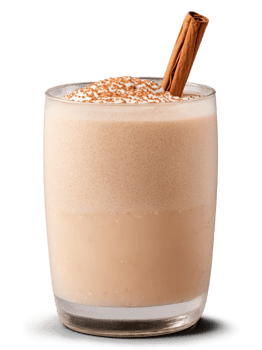 Spanish Horchata in clear glass garnished with sprinkle of cinnamon and few ice cubes png