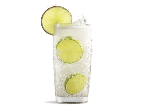 Coconut soda in a tall glass coconut flakes and lime wedges dynamic white splash tropical png