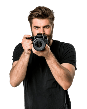 Bearded man with brown hair is holding a camera, pointing it towards the viewer photography Transparent Background png