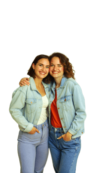 Two Smiling Women Wearing Denim Jackets Pose Together png