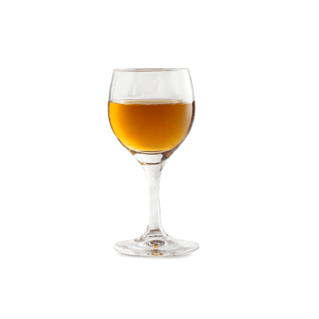 Cordial glass small and delicate holding a rich dark liqueur that coats the sides with png