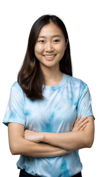 Young Woman Smiling While Standing With Arms Crossed in Light Blue Tie-Dye T-Shirt png