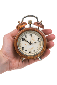Hand holding alarm clock, isolated against transparent background png