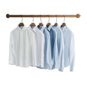 Collection of dress shirts hanging in a closet png