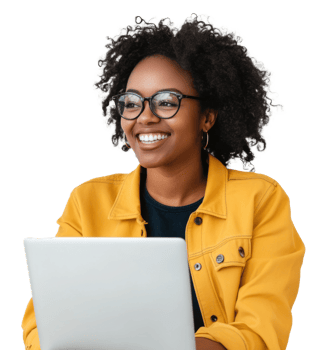 A smiling woman with curly hair works on a laptop while wearing a yellow jacket in a bright setting, cut out - stock . png