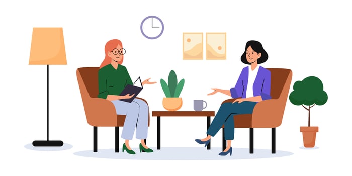 Two women engaged in conversation in a cozy living room setting during the afternoon vector