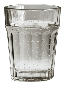Clear glass filled with sparkling water on a table isolated on transparent background png